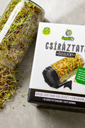 Legeldle csíráztató üvegedény, fekete színű dobozával és egy üveg, amiből ömlenek ki a csírák.